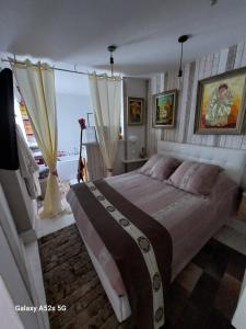 a bedroom with a large bed and a window at Demeure Prosper 1 chambre d'hôte avec petit déjeuner compris in Labégude