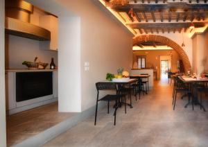 a dining room with tables and chairs in a building at Casa Eufemia Cozy Apartments in Mugnano