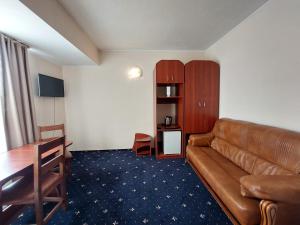 a living room with a couch and a table at Hotel Egreta in Tulcea
