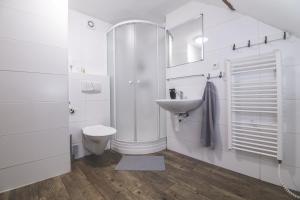 uma casa de banho branca com um lavatório e um WC em Chalupa Hejmovka em Spindleruv Mlyn