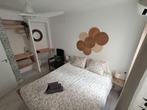 a bedroom with a bed with a white comforter at Casa Peña in Málaga