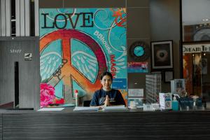 a young man sitting at a desk in a store at BBHouse Khlongtan in Bangkok