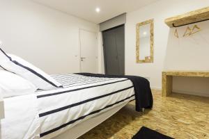 a bedroom with a bed and a fireplace at Quinta das Rosas Villas in Ribeira Grande
