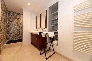 a bathroom with a sink and a mirror at Home - Vildieu - Séjour à Coulanges in Coulanges-la-Vineuse