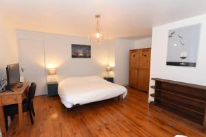 Dormitorio con cama, escritorio y TV en Home - Vildieu - Séjour à Coulanges en Coulanges-la-Vineuse