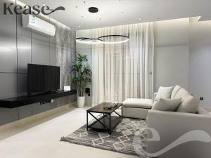 a living room with a couch and a tv at Kease Tawun B3-11 Royal touch Balcony AZ24 in Riyadh