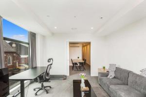 a living room with a couch and a table at Cozy apartment by Eden Park in Auckland