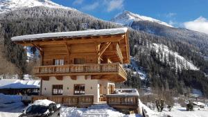 a log cabin in the mountains with snow on it at Hideaway Eggerfeld in Flattach