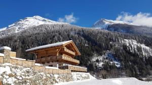 a building on the side of a snow covered mountain at Hideaway Eggerfeld in Flattach