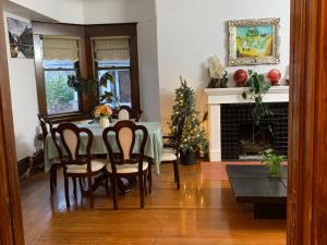 a dining room with a table and a christmas tree at Broadway guest house in Vancouver