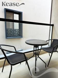 a table and two chairs on a balcony at Kease Tawun B3-11 Royal touch Balcony AZ24 in Riyadh