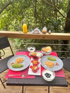 a picnic table with plates of food on it at La Chagra VIP in Villavicencio