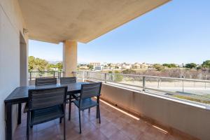 a dining room with a table and chairs on a balcony at Hauzify I Apartament Oliveres in Hospitalet de l'Infant
