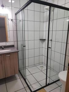 a bathroom with a shower with a glass door at PORTAL PARQUE HOTEL in Francisco Beltrão