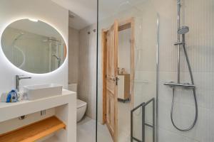 een badkamer met een douche, een wastafel en een spiegel bij Limoncello in Denia