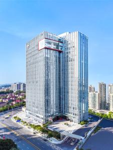 an aerial view of a tall building in a city at Sha Zhi Ye Serviced Apartment Hotel - Houjie Wanda Plaza Liaoxia Subway Station in Dongguan