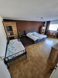 a bedroom with two beds and a living room at Marcel's Appartement in Bielefeld