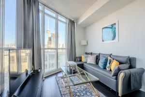 a living room with a couch and a large window at GLOBALSTAY. Elegant Downtown Apartments in Toronto