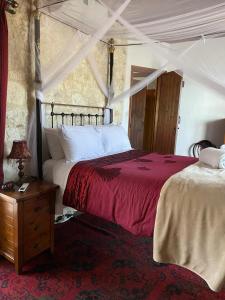a bedroom with two beds and a table with a lamp at Afames House - Beautiful Traditional House in Omodos