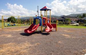 a playground with a slide in a parking lot at Drax Hall Country Club in Mammee Bay