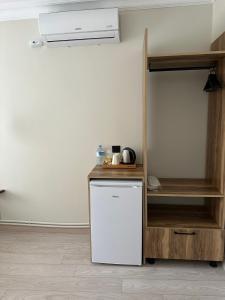 a kitchen with a white refrigerator and a shelf at Kingway Suite in Nusratlı