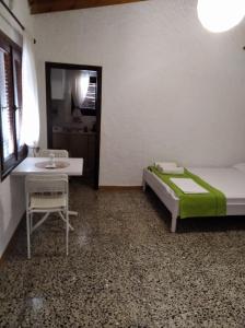 a bedroom with a bed and a table and a window at Ioanna's house #dialiskari1# in Limnionas