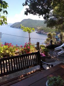 a bench with a view of the ocean at Ioanna's house #dialiskari1# in Limnionas