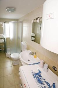 a bathroom with a sink and a toilet and a mirror at Apartment Old Town - Bambo in Knin
