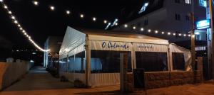 a white building with lights on the side of a building at Apartamentos Colmado in Sanxenxo +4 photos