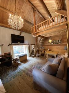 a living room with a couch and a wooden ceiling at Romantikchalet in Flattach