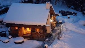 a log cabin in the snow with a light on at Romantikchalet in Flattach