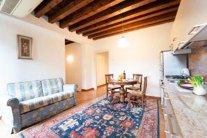 a kitchen and living room with a table and a couch at Furlani Apartments in Venice