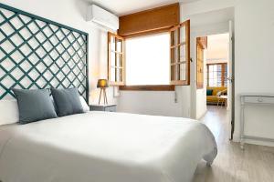 Cama ou camas em um quarto em Apartamentos Vela Blanca