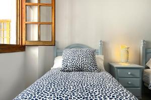 Cama ou camas em um quarto em Apartamentos Vela Blanca