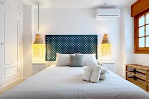 Cama ou camas em um quarto em Apartamentos Vela Blanca