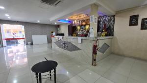 a bar in a restaurant with a counter and a stool at SP Venture Boutique Hotel in Rawang