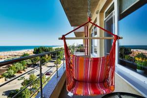 una hamaca colgada de un balcón con vistas a la playa en Mamaia Summerland Sunwaves en Mamaia