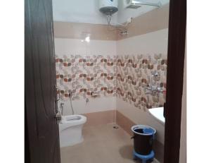 a bathroom with a toilet and a sink at Ashgrove village resort, Kempty fall in Lakhwār