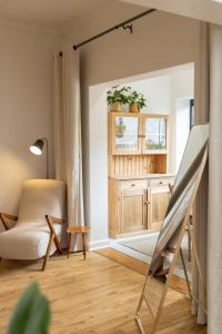 a living room with a easel and a chair at Boho Chic Studio Stellenbosch in Stellenbosch