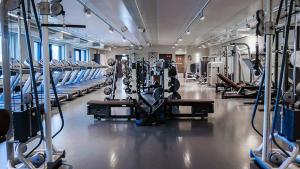 a gym with rows of treadmills and machines at Best place when in Oslo? Breathtaking view - Spacious - Self check in in Røa