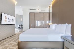 a large white bed in a hotel room at Spacious Studio Apartment in Hyatt Regency Dubai Creek Heights by the S Holiday Homes in Dubai