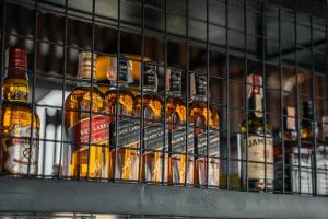 a bunch of bottles of alcohol on a shelf at Yello Hotel Cebu powered by Cocotel in Cebu City