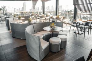 a restaurant with tables and chairs and a view of the city at Yello Hotel Cebu powered by Cocotel in Cebu City