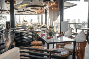 a restaurant with tables and chairs and a view of the city at Yello Hotel Cebu powered by Cocotel in Cebu City