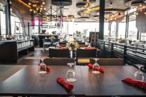 a wooden table with red napkins and wine glasses on it at Yello Hotel Cebu powered by Cocotel in Cebu City