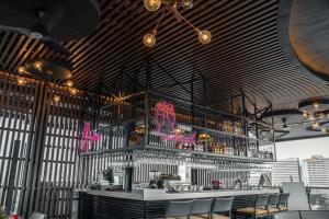 a bar in a restaurant with a lot of drinks at Yello Hotel Cebu powered by Cocotel in Cebu City