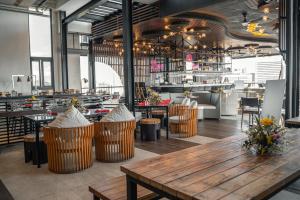 a restaurant with a wooden table and chairs at Yello Hotel Cebu powered by Cocotel in Cebu City