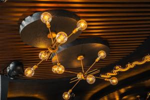 a chandelier hanging from a ceiling in a room at Yello Hotel Cebu powered by Cocotel in Cebu City