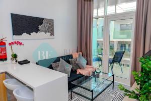 uma sala de estar com um sofá e uma mesa de vidro em Modern 1 Bedroom In Oasis2 em Abu Dhabi