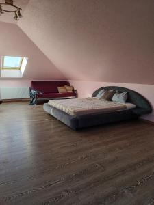 a bedroom with a large bed in a attic at Pajūrio Brizo Kotedžas in Klaipėda